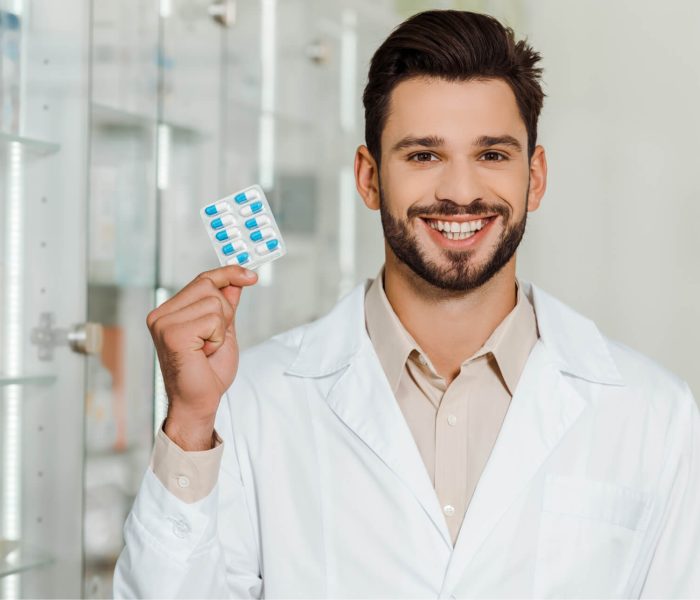 Services handsome-pharmacist-smiling-at-camera-while-holdin-2023-11-27-05-12-27-utc.jpg